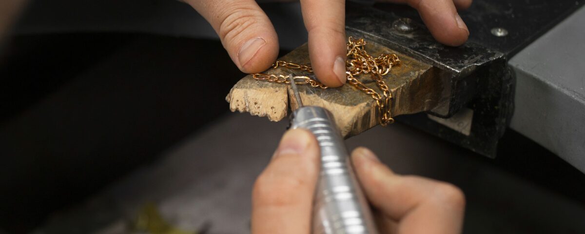 Joyero trabajando con una cadena de oro